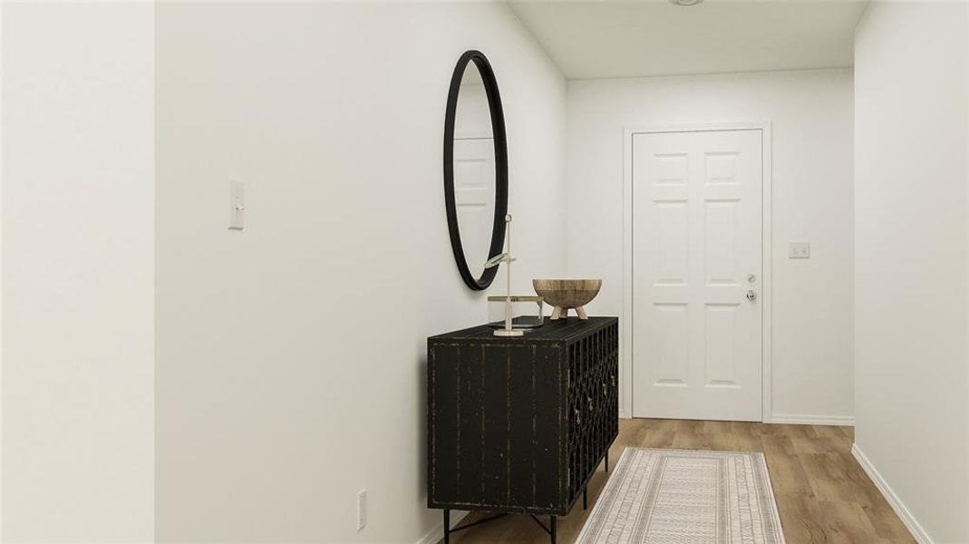 Hallway with wood finished floors and baseboards Hallway with wood finished floors and baseboards