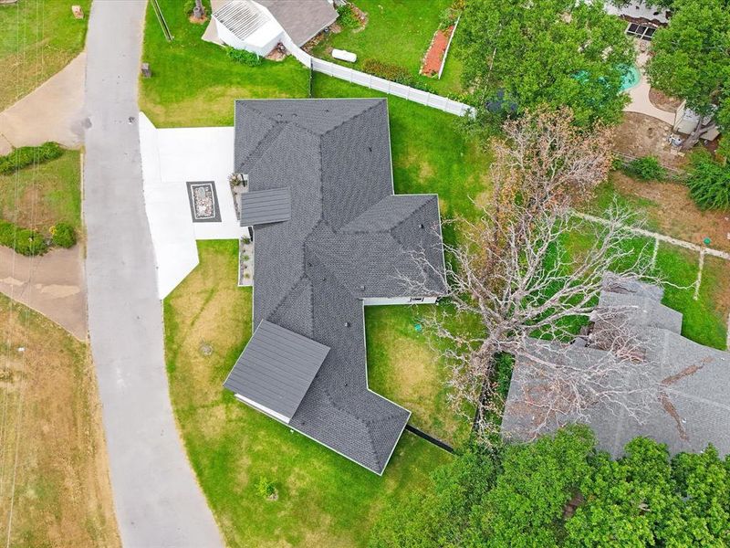 Contemporary roofline featuring dark shingles and a metal roof accent