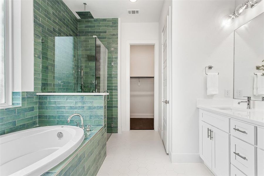 Bathroom with vanity, tile patterned floors, and separate shower and tub