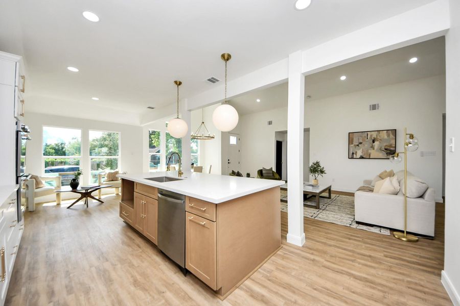 This modern kitchen strikes the perfect balance between style and function. White cabinetry and stainless steel accents feel fresh and refined, while warm wood-like floors and pendant lighting add an inviting touch. The oversized island is more than just a workspace—it’s a natural gathering spot that flows effortlessly into the heart of the home. This modern kitchen strikes the perfect balance between style and function. White cabinetry and stainless steel accents feel fresh and refined, while warm wood-like floors and pendant lighting add an inviting touch. The oversized island is more than just a workspace—it’s a natural gathering spot that flows effortlessly into the heart of the home.