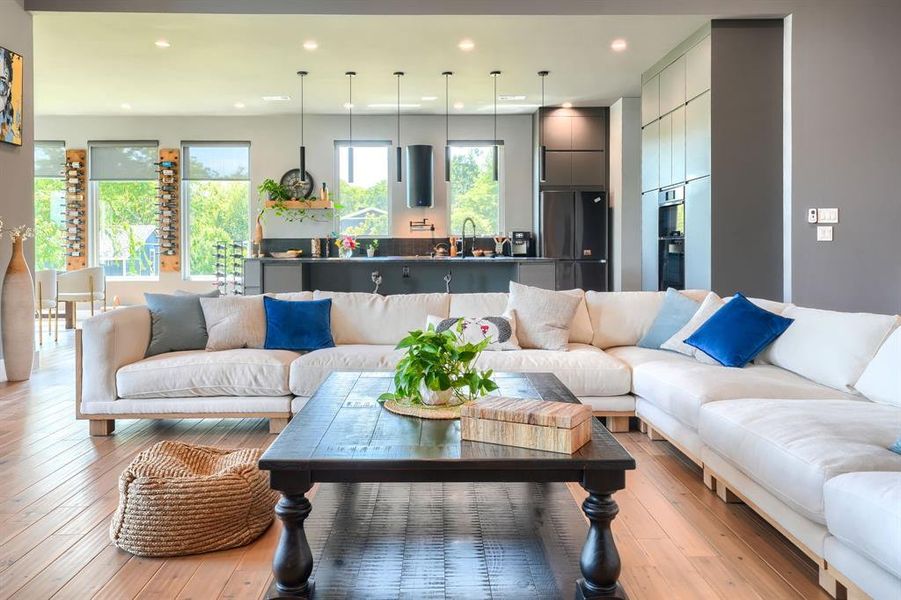 Living room with recessed lighting and light wood-style flooring Living room with recessed lighting and light wood-style flooring