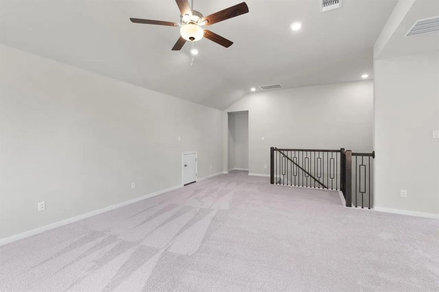 A spacious, naturally illuminated bonus room awaits, offering ample space for diverse activities.