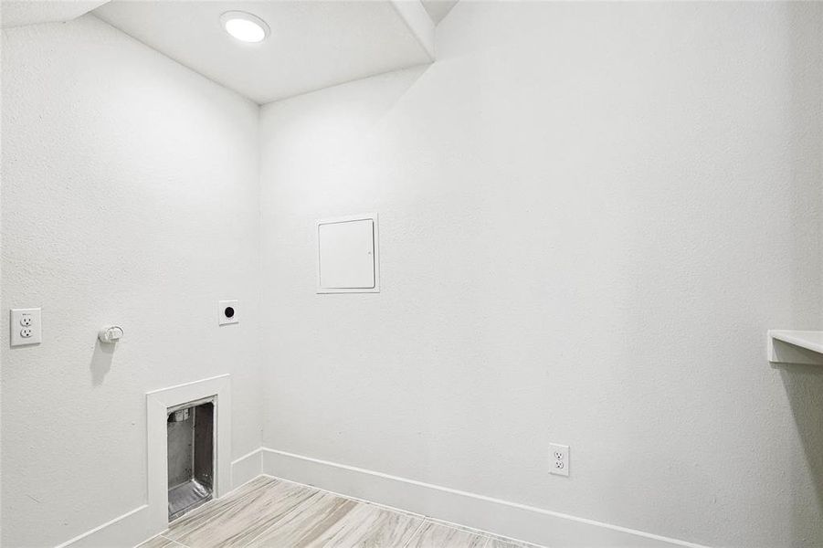 Clothes washing area featuring hookup for an electric dryer