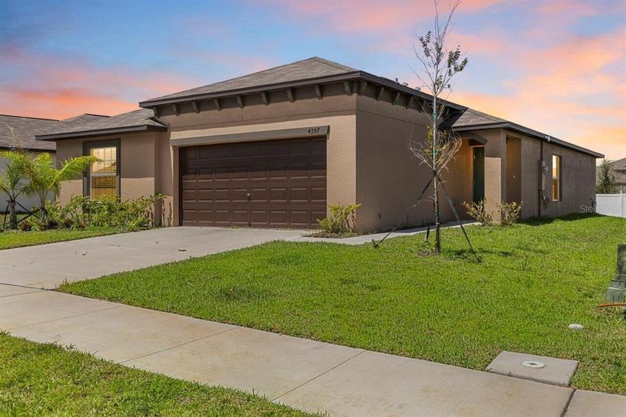 Front exterior of a new home in Wind Meadows South, Bartow, FL, highlighting curb appeal (Image 28).