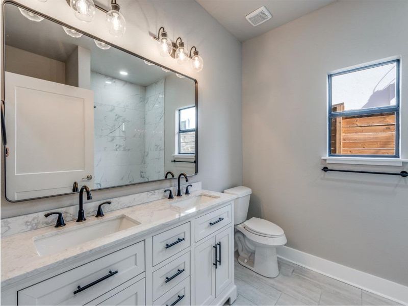 Bathroom with double vanity and a shower