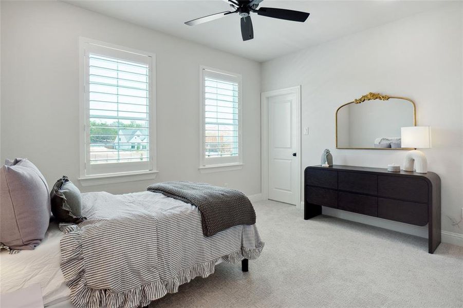 Bedroom featuring light carpet and ceiling fan