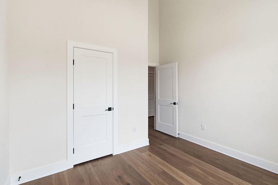 Natural wood flooring complements clean white walls and doors in this versatile space. Natural wood flooring complements clean white walls and doors in this versatile space.