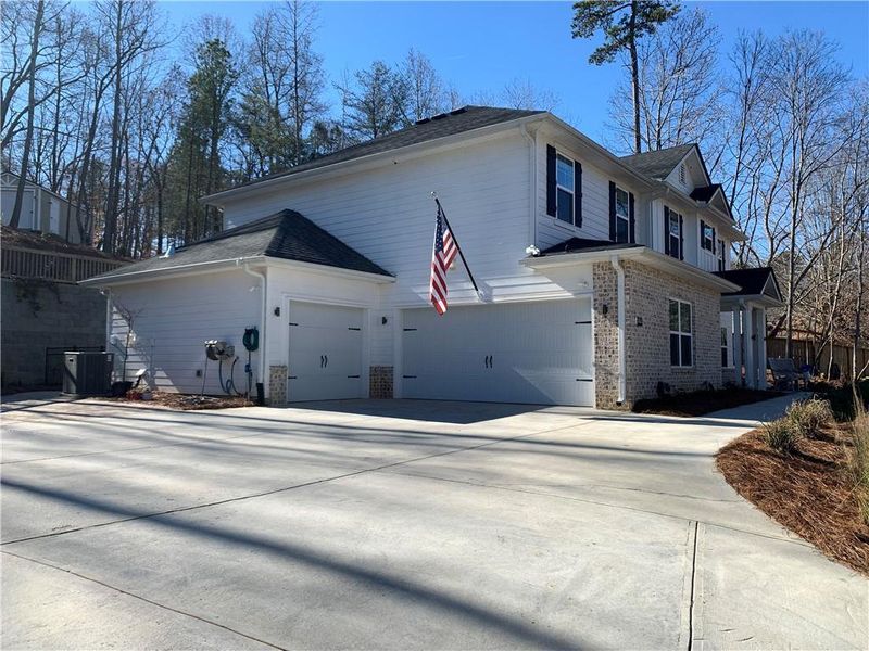 Front exterior of a new home in Holiday Pines, Buford, GA, highlighting curb appeal (Image 22).