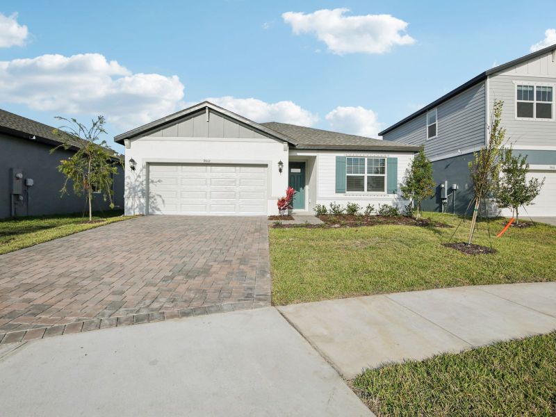 Front exterior of a new home in Coasterra - Reserve Series, Palmetto, FL, highlighting curb appeal (Image 2). Front exterior of a new home in Coasterra - Reserve Series, Palmetto, FL, highlighting curb appeal (Image 2).