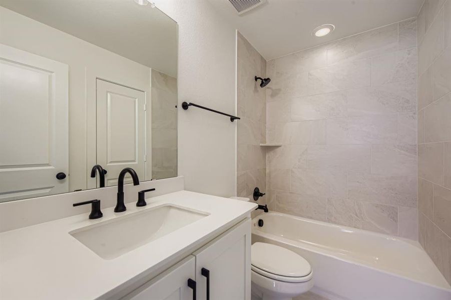 Full bathroom with bathing tub / shower combination, vanity, and recessed lighting