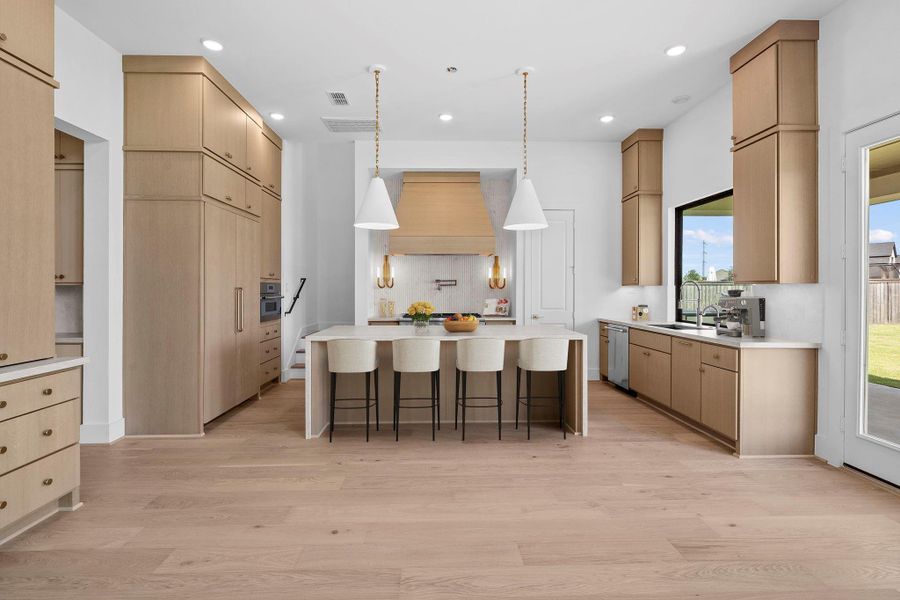 *Virtual Staging* Gourmet kitchen featuring a large center island, custom cabinetry, and sophisticated finishes.