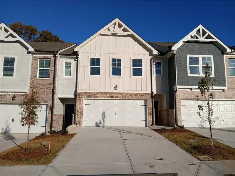 Front exterior of a new home in Union Village, McDonough, GA, highlighting curb appeal (Image 1).