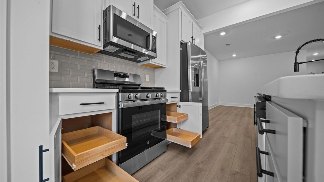 Tasteful design meets functional luxury in this kitchen with a 9-foot island and modern pendant lighting