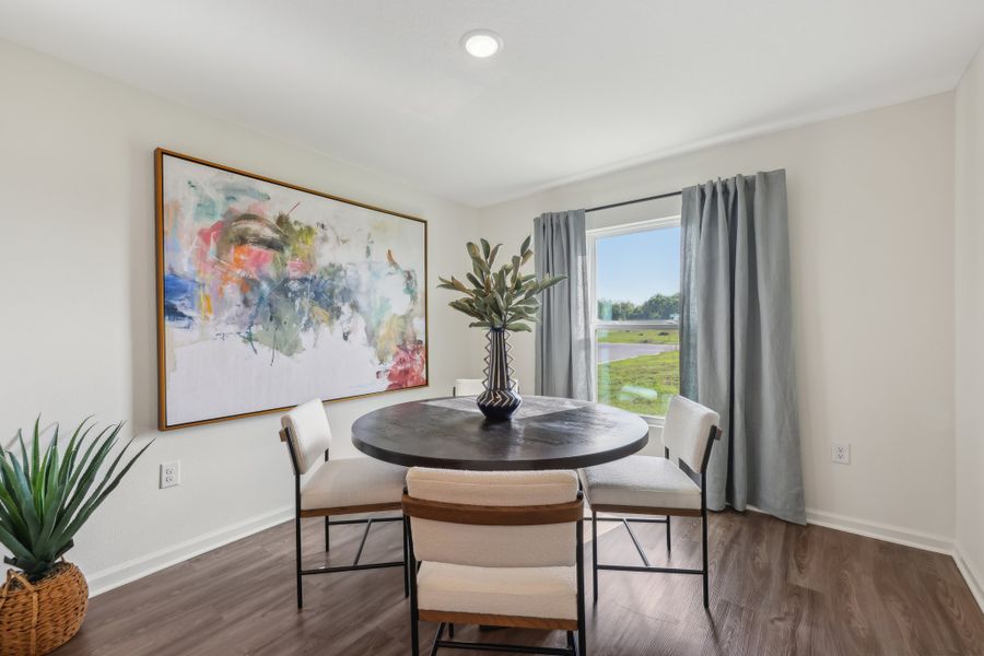 A dining room table with chairs.