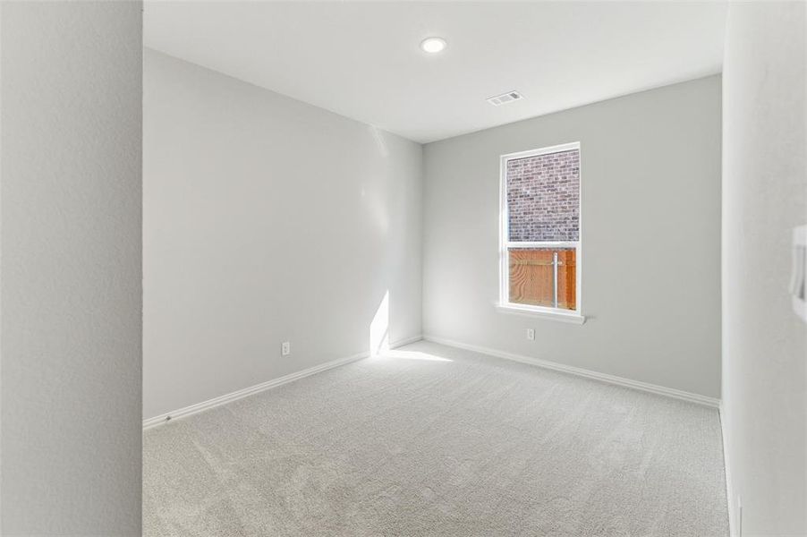 Carpeted empty room with baseboards