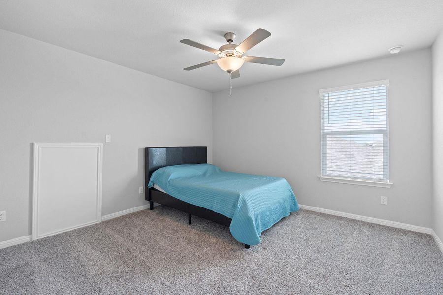 Bedroom with baseboards, carpet flooring, and ceiling fan Bedroom with baseboards, carpet flooring, and ceiling fan