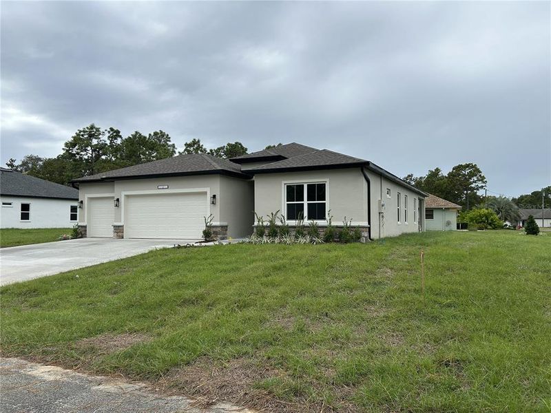 Front exterior of a new home in , Dunnellon, FL, highlighting curb appeal (Image 17).
