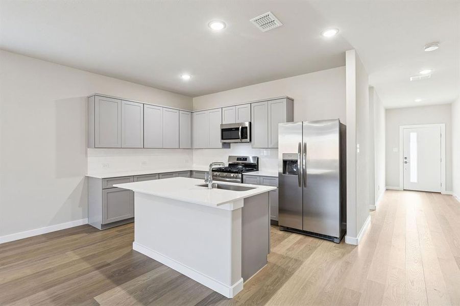 Kitchen in the Haylee home plan by Trophy Signature Homes - REPRESENTATIVE PHOTO