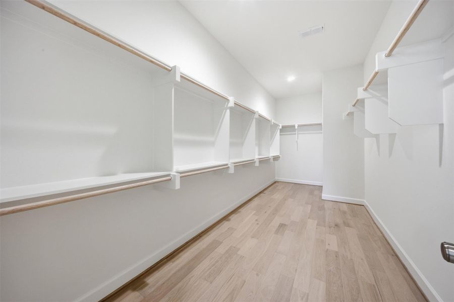 Large walk-in closet with extensive hanging space, organization, and room for a luxury boutique-style wardrobe experience.