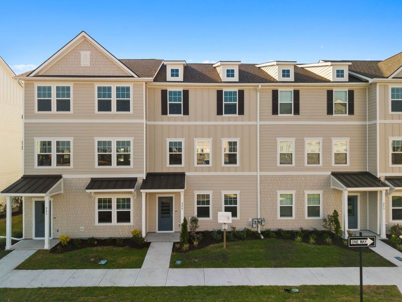 Front exterior of a new home in Lakeside Townes at Riverlights, Wilmington, NC, highlighting curb appeal (Image 1). Front exterior of a new home in Lakeside Townes at Riverlights, Wilmington, NC, highlighting curb appeal (Image 1).