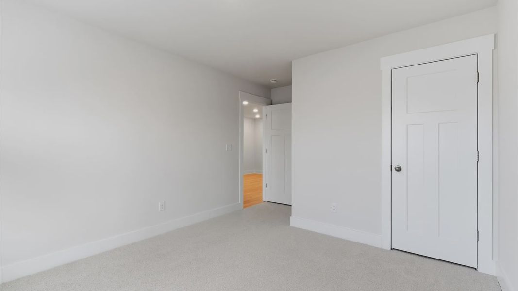 Notable secondary bedroom offering cozy carpeted flooring and a stylish walk-in closet located in Greenville, SC