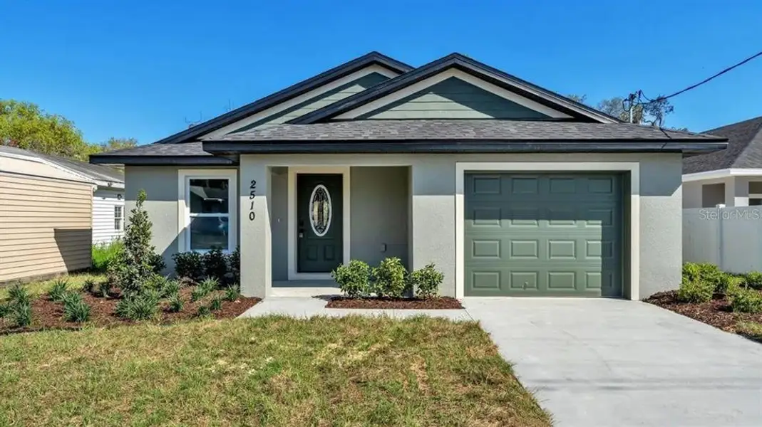Front exterior of a new home in , Winter Haven, FL, highlighting curb appeal (Image 1). Front exterior of a new home in , Winter Haven, FL, highlighting curb appeal (Image 1).