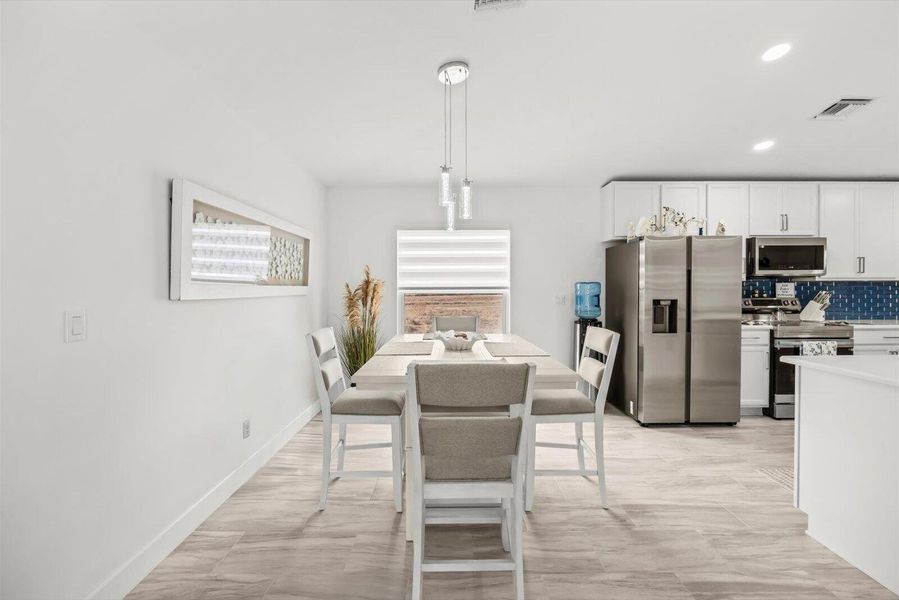 Sun-Filled Dining Space Featuring Large Windows and Natural Light