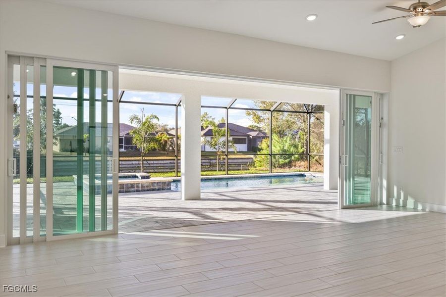 Doorway to outside with healthy amount of natural light, wood tiled floors, ceiling fan, and recessed lighting