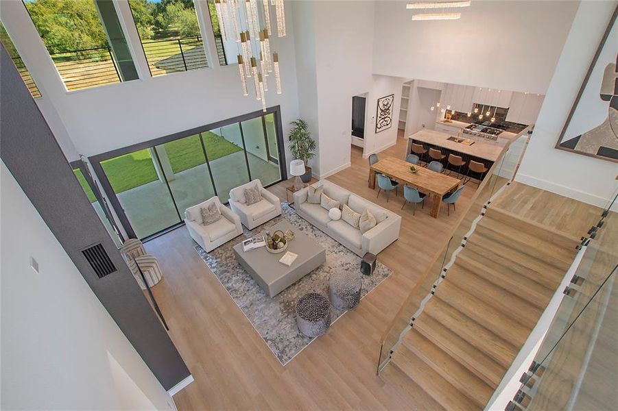 Living room featuring a notable chandelier, a high ceiling, and hardwood / wood-style flooring