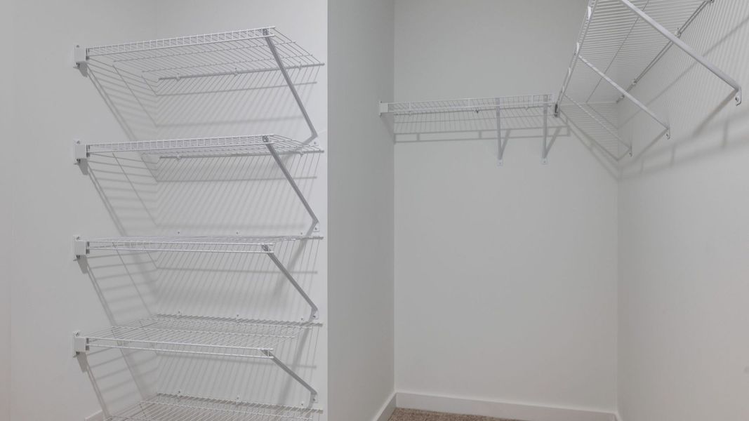 Primary walk-in closet with various racks for convenience