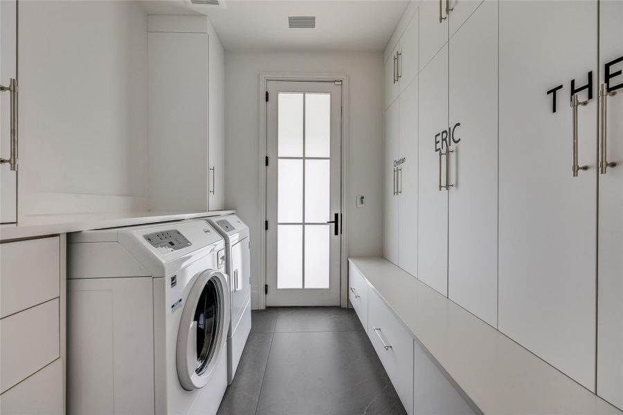 Downstairs laundry room/mudroom with seller-added custom built-in cabinetry