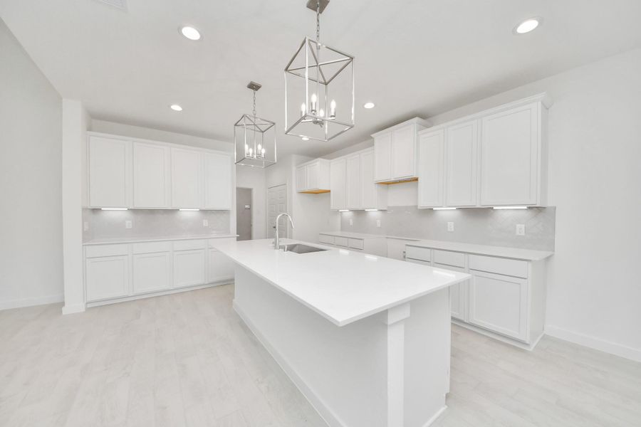 The kitchen is a culinary haven, featuring granite countertops, a tile backsplash, stainless steel appliances, 42” upper cabinets, and undercabinet lighting. The kitchen is a culinary haven, featuring granite countertops, a tile backsplash, stainless steel appliances, 42” upper cabinets, and undercabinet lighting.