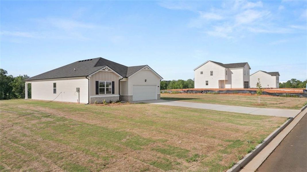 Front exterior of a new home in Champion's Run, Lithonia, GA, highlighting curb appeal (Image 23).