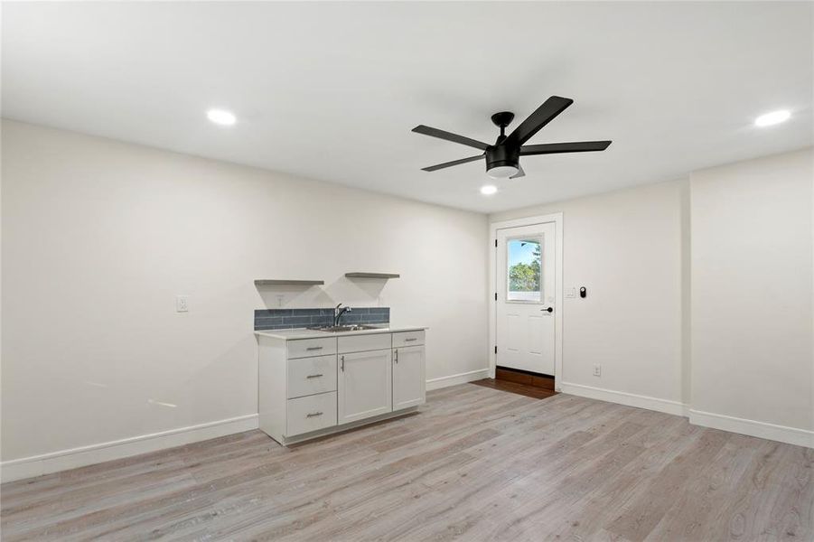Unfurnished living room featuring light wood-style floors, ceiling fan, and recessed lighting Unfurnished living room featuring light wood-style floors, ceiling fan, and recessed lighting