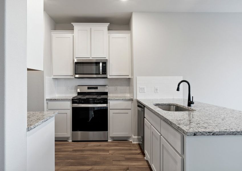 The kitchen of the St. Clair has beautiful white wood cabinets.