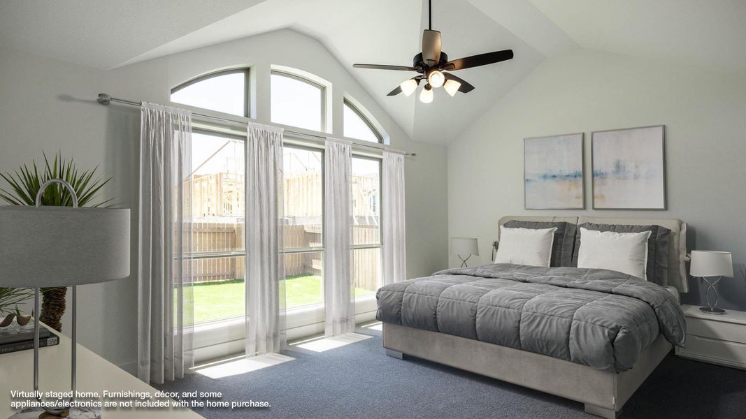 Carpeted bedroom with ceiling fan, multiple windows, and vaulted ceiling Carpeted bedroom with ceiling fan, multiple windows, and vaulted ceiling