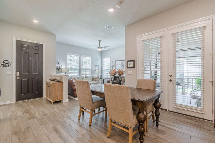 Dining room featuring light wood finished floors, ceiling fan, recessed lighting, and baseboards