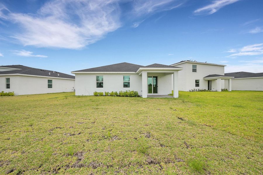 Front exterior of a new home in Seagrove: The Indies, Fort Pierce, FL, highlighting curb appeal (Image 17). Front exterior of a new home in Seagrove: The Indies, Fort Pierce, FL, highlighting curb appeal (Image 17).
