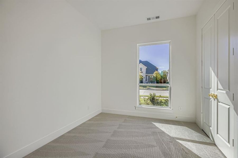 Spare room featuring baseboards and carpet floors Spare room featuring baseboards and carpet floors