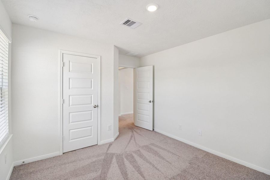 View from secondary bedroom into hallway.
