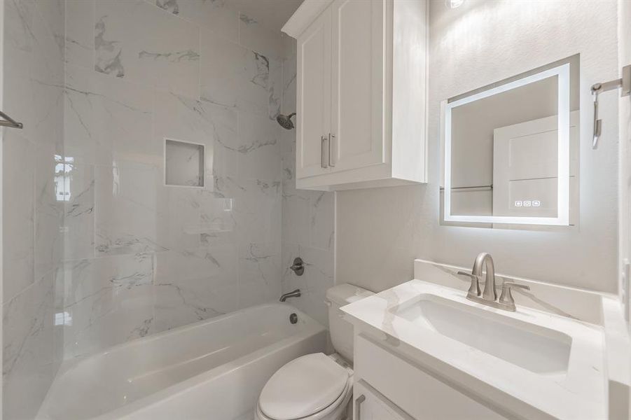 Bathroom featuring vanity and shower / bath combination