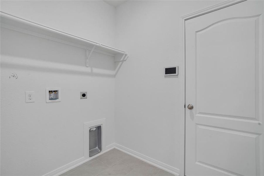 The Utility Room is spacious for your washer & dryer appliances and has a high shelf for all your laundering supplies.