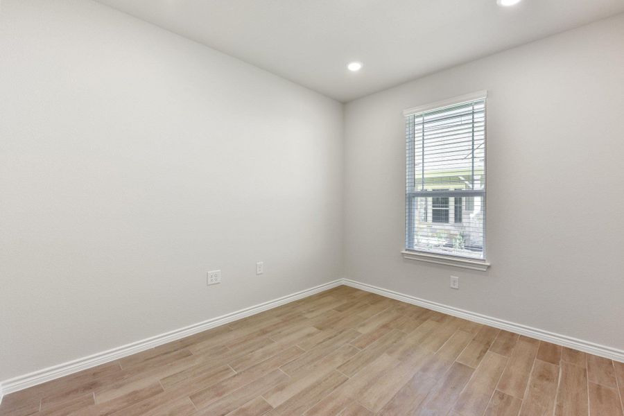Spare room with light wood-type flooring and recessed lighting
