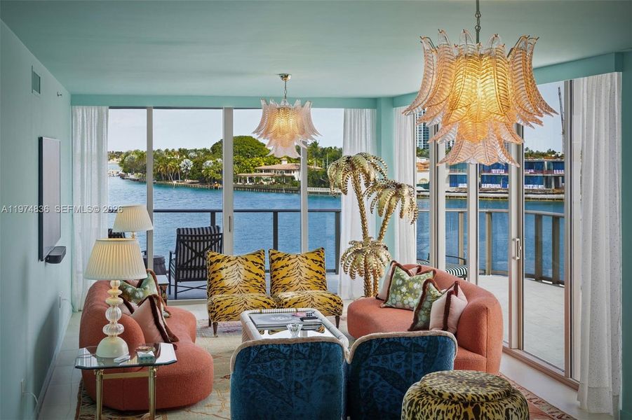 Waterfront corner living room with floor to ceiling glass and wrap around terrace