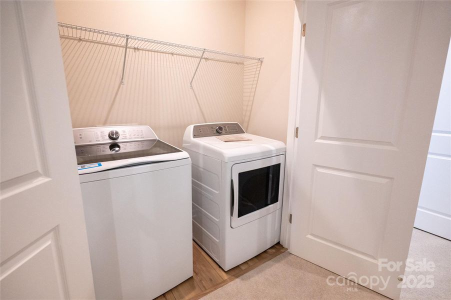 Laundry space with included washer dryer.