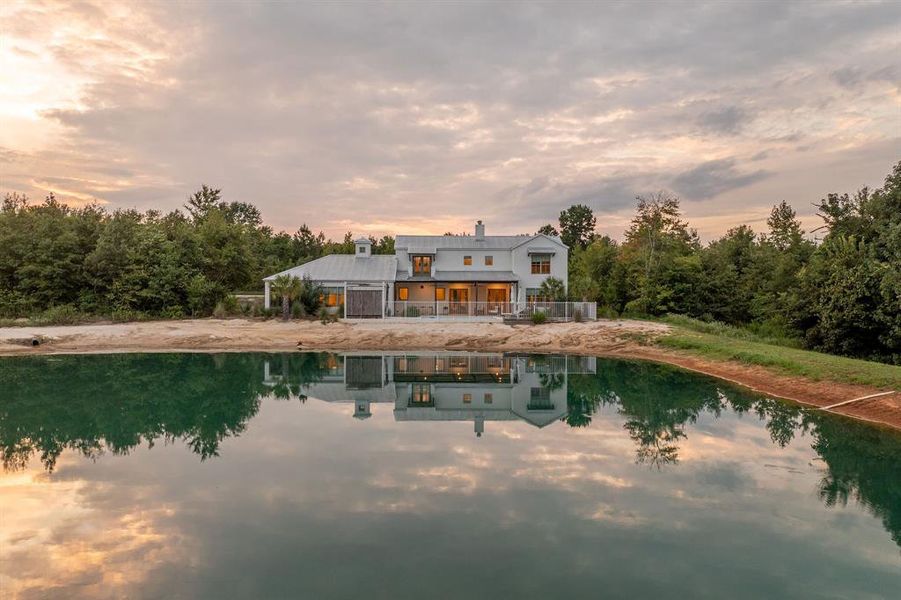 Rear view of property with an outdoor pool, stucco siding, a chimney, a wooden deck, and french doors Rear view of property with an outdoor pool, stucco siding, a chimney, a wooden deck, and french doors