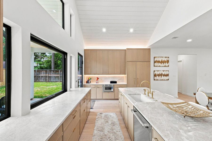 Kitchen with custom cabinets, Taj Mahal countertops, and Thermadore appliances.