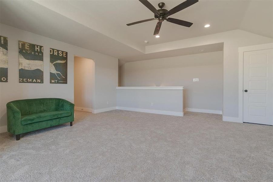 Sitting room featuring ceiling fan and light colored carpet