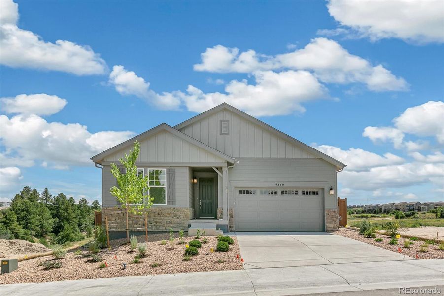 Front exterior of a new home in Terrain Oak Valley, Castle Rock, CO, highlighting curb appeal (Image 1).