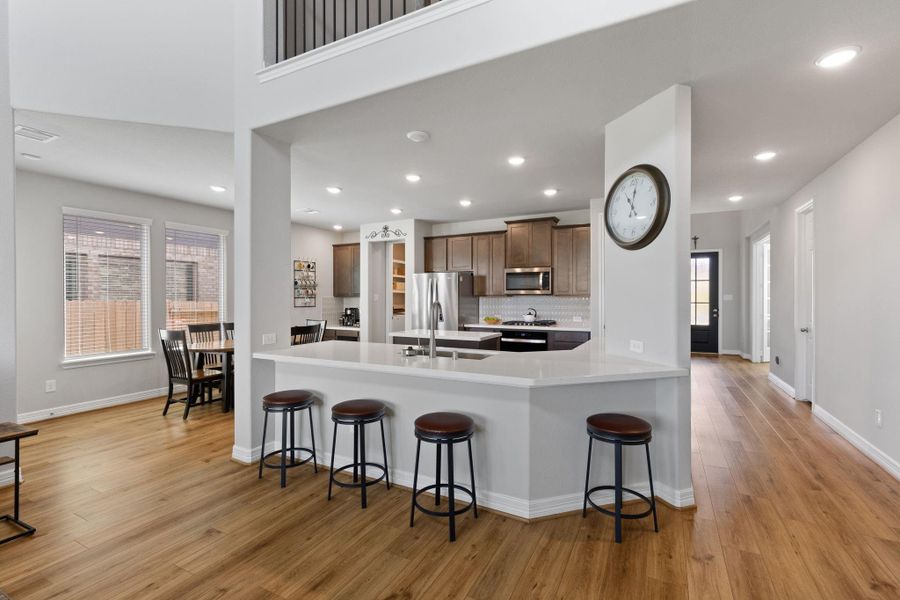 Open concept living with chef's kitchen and dining area with easy access to the family room.